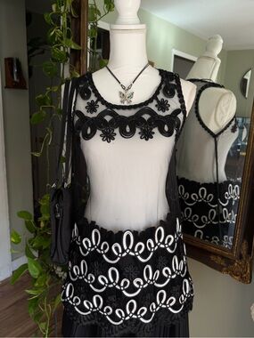 Somya brand Black whimsy lace top with white scrollwork embroidery